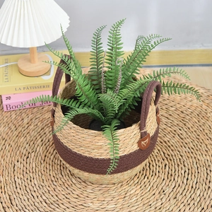 Detail of woven seagrass plant basket with leather buckles and dual handles