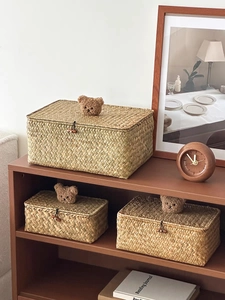 Macro shot of natural seagrass storage baskets with wooden buttons and plush bear decor