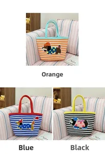 Detailed view of woven tote bags with striped patterns and cute embroidered puppies