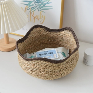 Detailed close-up of a woven seagrass basket with wavy brown trim for home storage