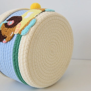 Macro shot of cotton woven gift basket with colorful tufted embroidery and striped texture