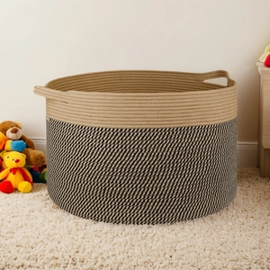 Close-up of woven cotton rope laundry basket with dual-tone texture on soft white rug