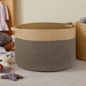 Detail of a large cotton rope storage basket featuring dual-tone weave and sturdy handles
