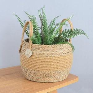 Detail of woven seagrass plant basket showing sturdy handles and natural fiber texture