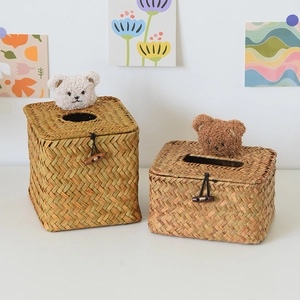 Detail of hand-woven straw tissue box with cute plush bears and button closure decoration