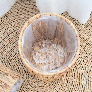 Close-up of woven water hyacinth basket featuring a waterproof plastic liner inside