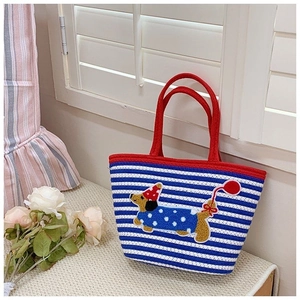 Detail of blue striped woven tote bag with cute embroidered dog and red handles