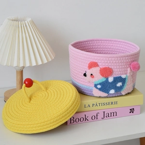 Close-up of pink and yellow woven cotton rope storage basket with cute animal design