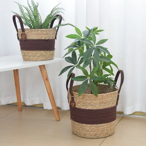 Detailed macro view of handcrafted woven plant basket with decorative brown cotton rope handles