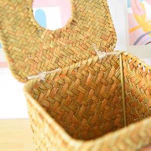 Close-up of handmade straw tissue box showing natural fiber texture and woven hinge