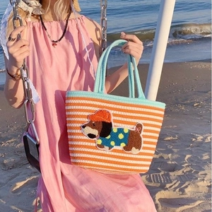 Detail of a woven cotton beach tote bag featuring a cute dog embroidery patch for daily use