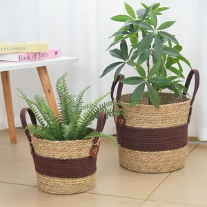 Detail of woven seagrass plant baskets with reinforced fabric handles in a home setting