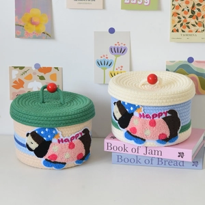 Detailed close-up of woven cotton storage baskets with cute cartoon dog embroidery and lids