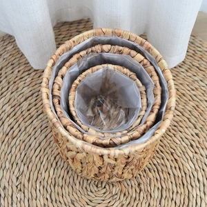 Macro detail of three-piece hand-woven water hyacinth storage baskets with waterproof liners