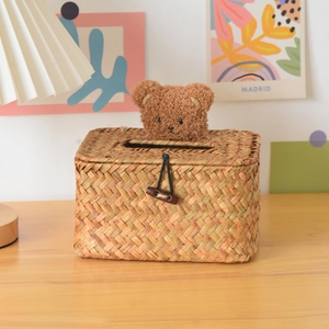 Detail of hand-woven straw tissue box with cute plush bear head and wooden button