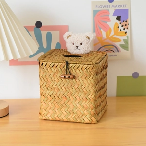 Detail of hand-woven straw tissue box with cute plush bear and wooden horn button