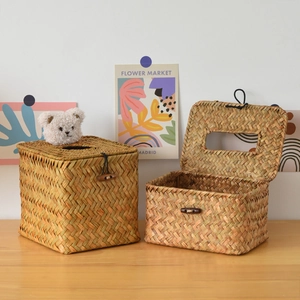 Detailed view of handmade woven straw tissue box with wood button and natural texture