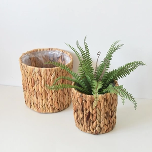 Detail of woven water hyacinth baskets with waterproof plastic liner for indoor plants