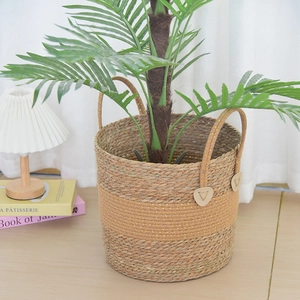 Detail of hand-woven seagrass basket with yellow sequin band and sturdy handles