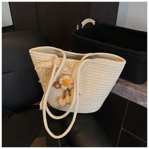 Close-up of cream woven tote bag featuring a lace bow and 3D floral charm detail