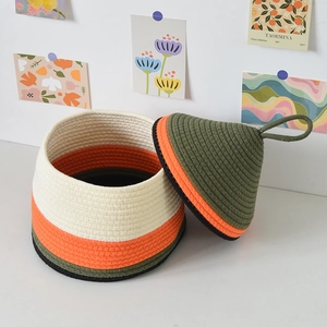 Macro detail of multi-colored cotton rope storage basket showing neat woven texture and lid