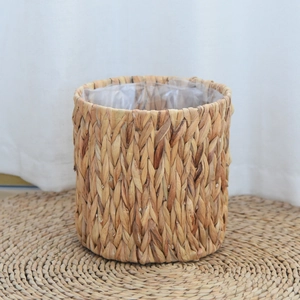 Detail of hand-woven water hyacinth planter with waterproof liner and matching round coaster