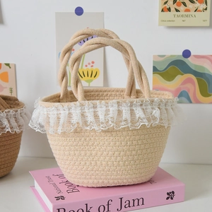 Detailed close-up of woven straw basket bag with elegant white lace trim and rope handles