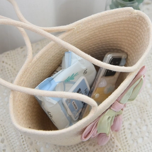 Detail view of woven cotton rope bag showing internal space with tulip decor