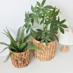 Close-up of handmade water hyacinth woven baskets with vibrant green artificial plants