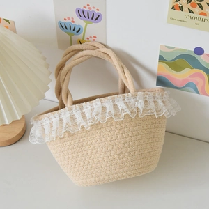 Detail of hand-woven straw bucket bag with white lace trim and thick cotton handles