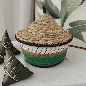 Detail of a handmade woven bucket gift box with a conical lid and natural grass texture