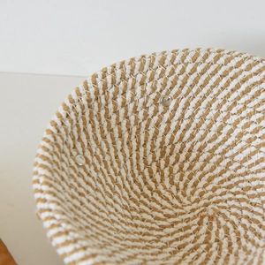 Close-up of handmade woven cotton bread proofing basket with metal rivet detail