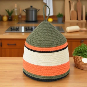 Detail of multi-color woven cotton rope lid cover with top loop for kitchen heat insulation