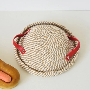 Macro detail of bottom of handwoven cotton bread proofing basket with red leather handles