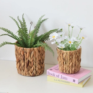 Handwoven water hyacinth storage baskets set with green plants and white daisies