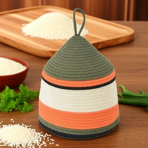 Detail of woven cotton rope storage basket with handle in striped green and orange