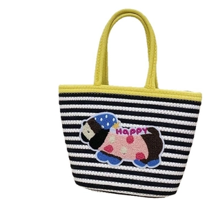 Large woven beach tote bag with black and white stripes and yellow handles