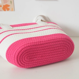 Detail of hand-woven cotton tote bag featuring pink and cream stripes and textured weave