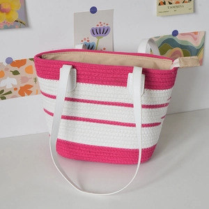 Detailed macro view of woven pink and white cotton tote bag showing zipper and PU strap