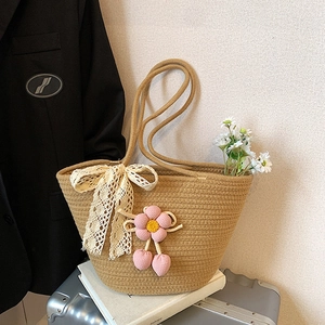 Straw woven tote bag with lace bow and cherry pendant for summer beach vacations
