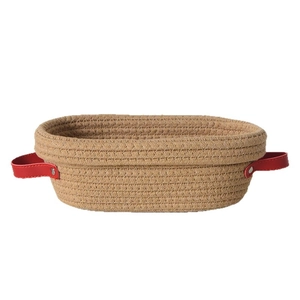 Oval woven bread proofing basket with natural jute texture and red leather handles