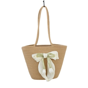 Handmade straw tote bag with rainbow bow detail for beach vacations and summer holidays
