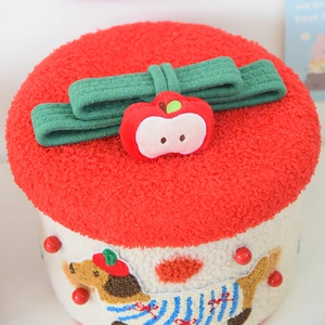 Detail of dachshund plush storage box featuring a red lamb wool lid and 3D apple decor