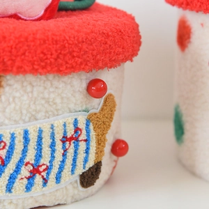 Detail of red fleece top and textured fabric on cute sausage dog storage box