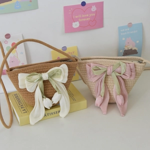 Close-up of handmade woven mini bucket bags with tulip pendants and large bow details