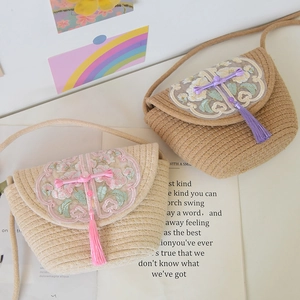 Detail of woven crossbody bags with Chinese embroidery, tassels, and traditional knots