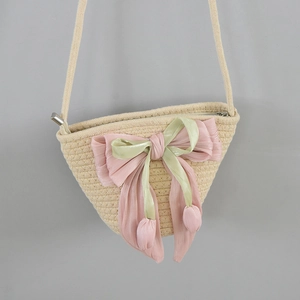 Close-up of woven bucket bag featuring pink tulip bows and detailed cotton rope texture