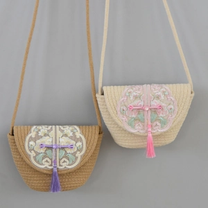 Handmade woven cotton tote bags in tan and cream with floral embroidery and tassels