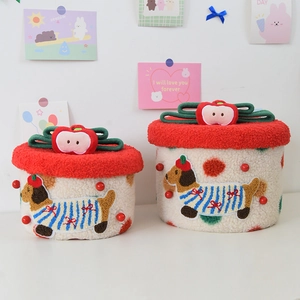Detail of cute dachshund beige sherpa storage basket with red apple plush lid decoration