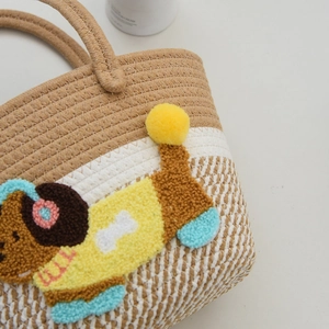 Close-up of woven tote bag texture featuring cute 3D cartoon dog embroidery detail